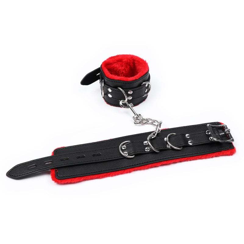 Red and black plush ankle restraint made of durable PVC with soft lining, featuring metal buckles and chains for adjustable fit and comfort.