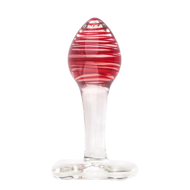 Clear glass butt plug with red swirling detail, 11 cm length, elegant and smooth design.